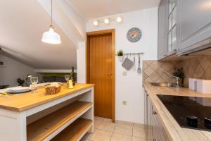 a kitchen with a wooden counter top and a sink at Pansion Tina in Šilo