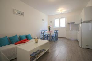 a living room with a bed and a table and a kitchen at Apartment in Porec/Istrien 10030 in Poreč