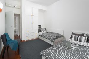 a bedroom with two beds and a desk with a laptop at Villa Pag in Mandre +12 photos