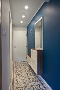 a room with a mirror, a sink, and a door at Momenti&Colori Studios in Sofia