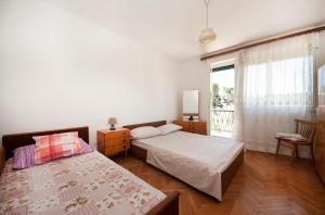a bedroom with two beds and a window at Holiday home Zlarin 1 in Zlarin