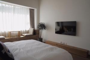 Hangzhou Moju Boutique Guesthouse at the West Lake客房内的一张或多张床位
