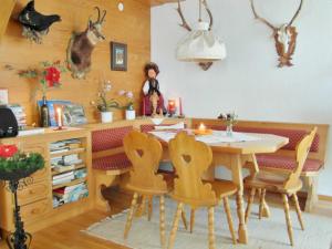 a dining room with a table and some antlers on the wall at Pension Stüttler in Schruns