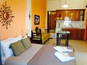 a living room with a bed and a kitchen at Pansion Zaharoula in Fira