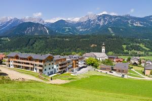 an aerial view of a building with mountains in the background at Appartement Klosterhügel in Haus im Ennstal