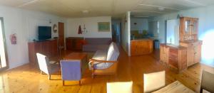 a living room with a couch and a table and chairs at David Bongers Still Bay Holiday Home in Stilbaai