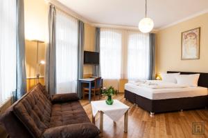 a hotel room with a bed and a couch at Hotel Silesia in Görlitz