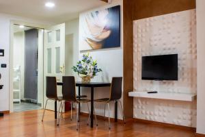 a dining room with a table and chairs and a tv at IDEAL LOFT IN CENTRO TORINO in Turin