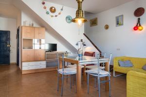 a kitchen with a table and chairs in a room at Ca l'Estany Clos in Tamariu