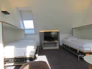 Postel nebo postele na pokoji v ubytování Comfor Hotel Ulm City
