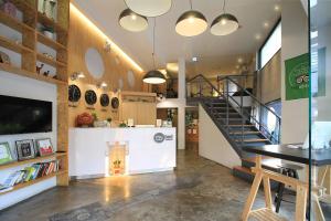 a room with a staircase and a table and a counter at Mybed Sathorn Hotel in Bangkok
