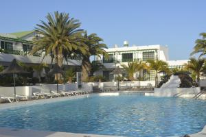 a swimming pool in front of a hotel at El Marinero in Puerto del Carmen