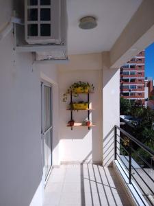 a balcony of a white building with shelves on the wall at Estudio centrico en Resistencia in Resistencia