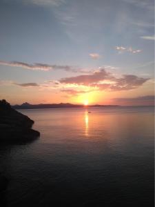 a sunset over a large body of water at RESIDENCE A MORTELLA - LIEU DIT TETTOLA in Saint-Florent