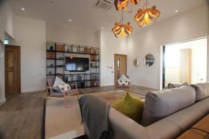 a living room with a couch and a tv at Berkshire House in Maidenhead