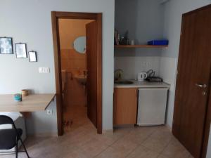 a small kitchen with a sink and a bathroom at Apartmani MiNa in Neum