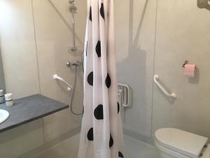 a bathroom with a toilet and a shower curtain at RESIDENCE A MORTELLA - LIEU DIT TETTOLA in Saint-Florent
