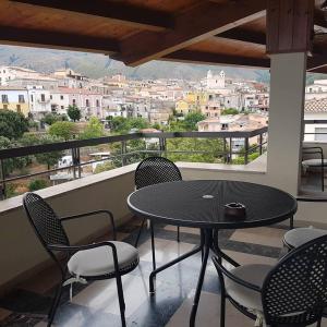 a table and chairs on a balcony with a view at Hotel Villa Principe in San Nicola Arcella