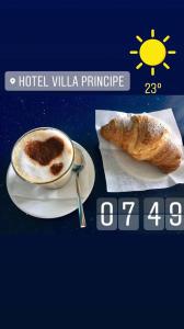 a picture of a cup of coffee and a plate of bread at Hotel Villa Principe in San Nicola Arcella
