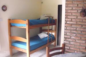 two bunk beds in a room with a brick wall at La Casa de Ana in Bialet Massé +35 photos
