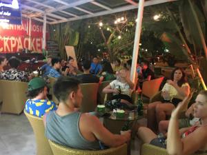 a group of people sitting in a restaurant at Catba Central Hostel in Cat Ba