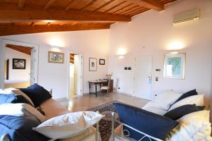 a living room with a couch and a table at Palazzo Sottile Meninni in Gravina in Puglia