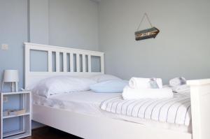 a white bed with white sheets and pillows at Marina - Holiday Home with Sea View in Makarska +40 photos
