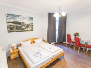 a bedroom with a bed and a dining room at Pension Marie Prenzlauer Berg in Berlin