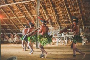 a group of men performing a dance in a room at Caboclos House Eco-Lodge in Manacapuru