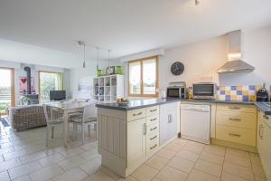 a kitchen with a table and a counter top at Les Costils in Saint-Laurent-sur-Mer