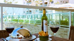 a table with a bottle of wine and two glasses at SALINAS PARK RESORT - Melhor Resort do Norte in Salinópolis
