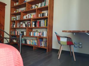 
a room with bookshelves, bookshelf, and a bed at B&B Le Mura in Grosseto
