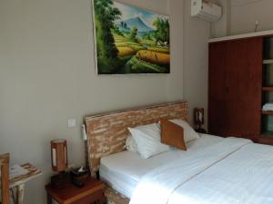 Postel nebo postele na pokoji v ubytování Umah Tikari Guesthouse