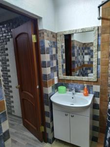 a bathroom with a sink and a mirror at Milo Apart Hotel in Karagandy +141 photos