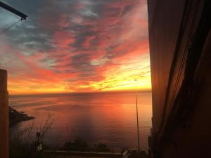 a sunset from a window with a view of the ocean at Hostal Gutierrez in Ceuta +20 photos