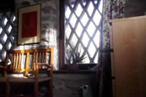 okno w pokoju z półką na książki i krzesłem w obiekcie Bellissimo Rustico A 7 km Dal Lago D'Orta w mieście Omegna