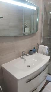 a bathroom with a white sink and a mirror at Apartment Mia in Hvar +28 photos
