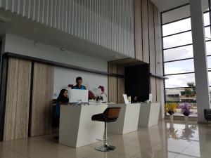 a man and a woman standing at a counter with a laptop at The Leverage Lite (Kuantan) in Kuantan