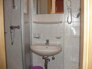 a bathroom with a sink and a shower at Pension Jägerheim in Krumbach +66 photos