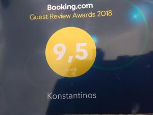 a yellow sign that reads guest review awards at Konstantinos in Áno Valsamóneron