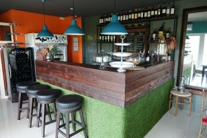 a bar with stools at the front of a restaurant at ibeyond Apartment Romklao Suvarnabhumi in Lat Krabang