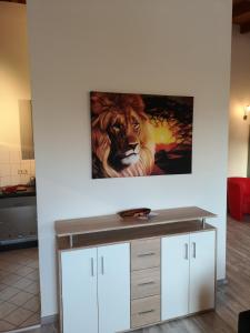 a painting of a lion on a wall at Ferienwohnung Kopp V in Greiz