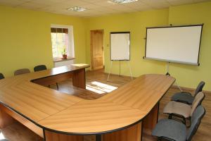 a meeting room with a table and a white board at Mała Sowa in Rzeczka