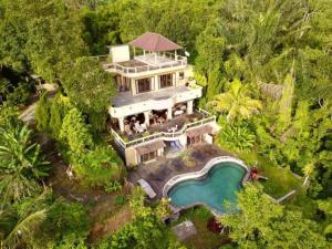 an aerial view of a large house with a swimming pool at DWan Tea Mountain Side in Jatiluwih