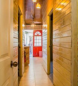 a hallway with a red door in a building at One32 Guesthouse Paradise in Kingston