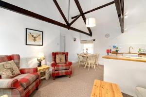 a living room with a couch and a table at Rose Cottage in Paignton