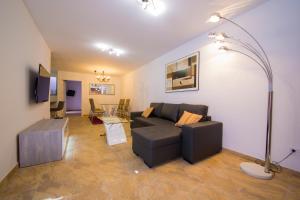 a living room with a couch and a table at Calle Lanzarote 29C in Playa del Ingles