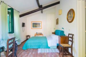 a bedroom with a bed and a table and chairs at Agriturismo La Montagnola in Torgiano +86 photos