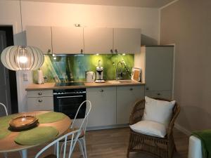 a kitchen with a table and a table and chairs at SEASIDE APT. - BEACHHOUSE SOUL in Eckernförde