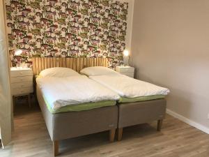 a bed in a bedroom with a wallpaper on the wall at SEASIDE APT. - BEACHHOUSE SOUL in Eckernförde